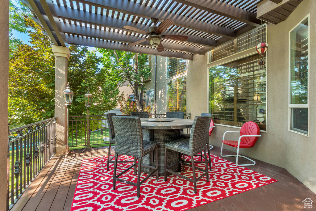 Wooden deck featuring a pergola and ceiling fan