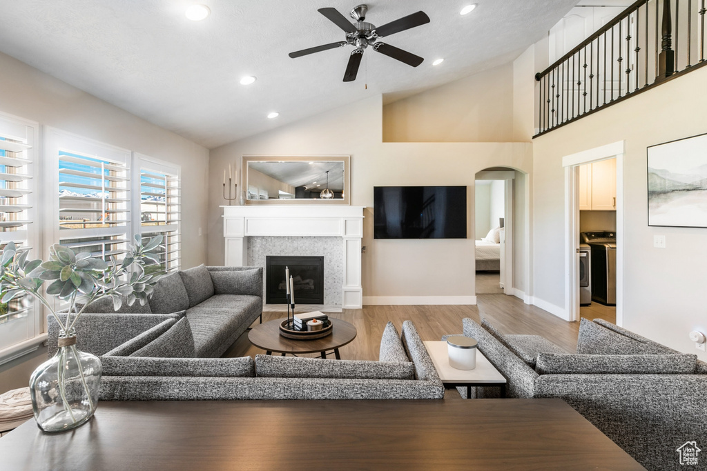 Living room featuring lofted ceiling, light hardwood / wood-style flooring, and ceiling fan