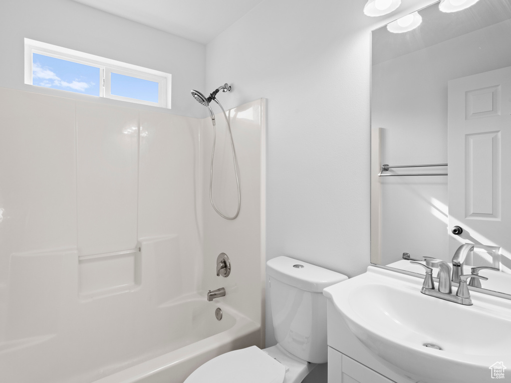 Full bathroom with shower / bathtub combination, vanity, and toilet