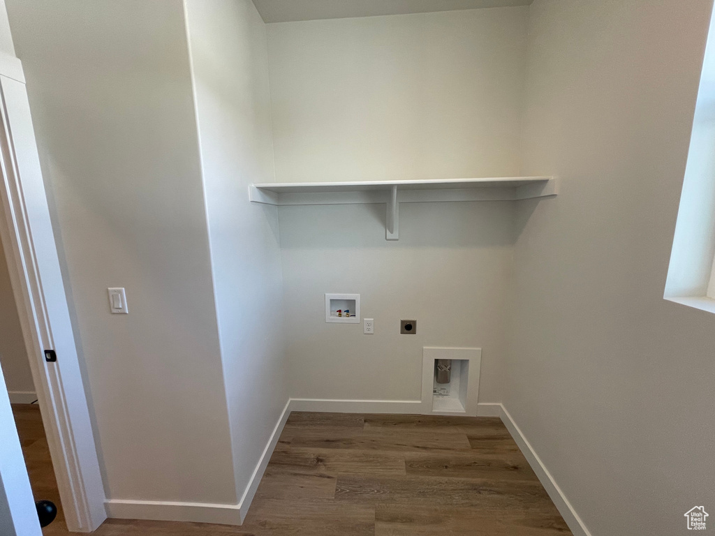 Laundry room with hookup for an electric dryer, hardwood / wood-style flooring, and washer hookup