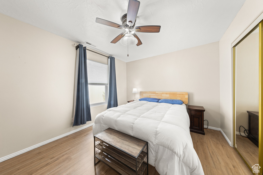 Bedroom featuring a closet, ceiling fan, and hardwood / wood-style floors