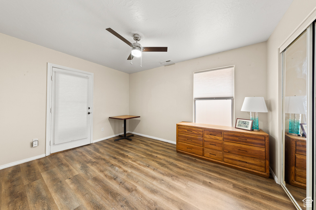 Unfurnished bedroom with wood-type flooring, ceiling fan, and a closet