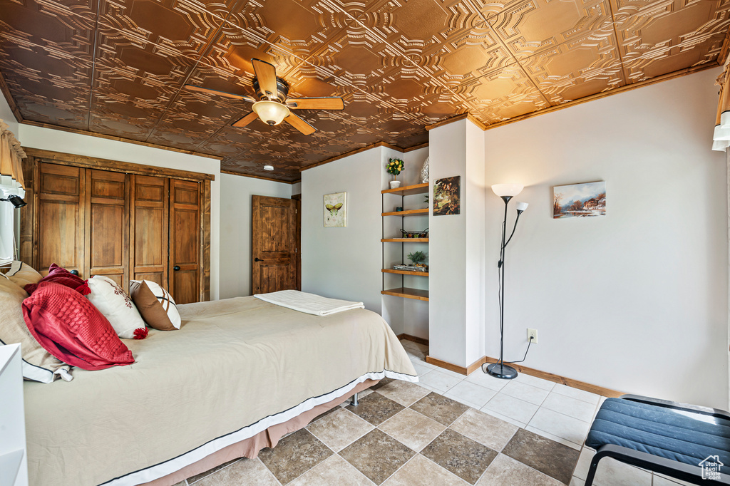 Tiled bedroom featuring a closet and ceiling fan