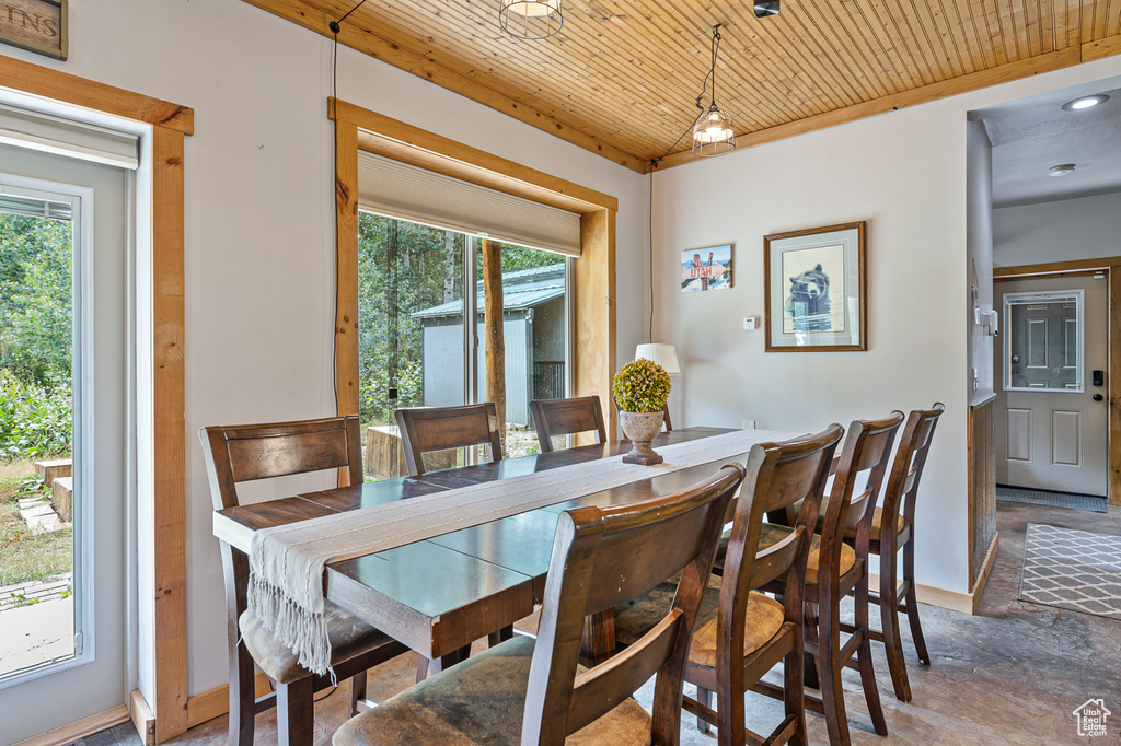 Dining room featuring wooden ceiling and plenty of natural light