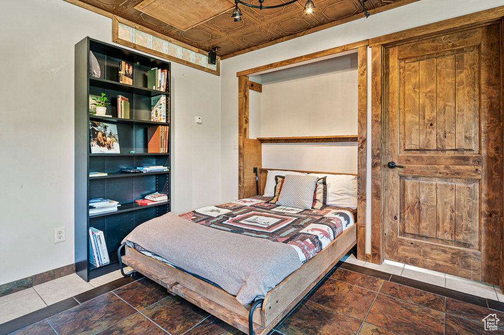 Tiled bedroom with wooden ceiling