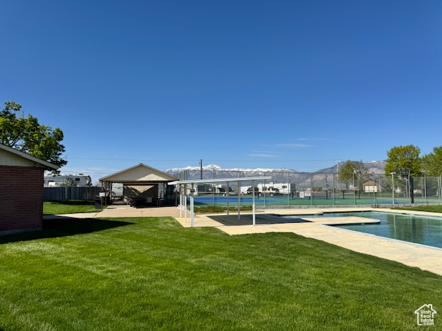 View of yard featuring a fenced in pool and a gazebo