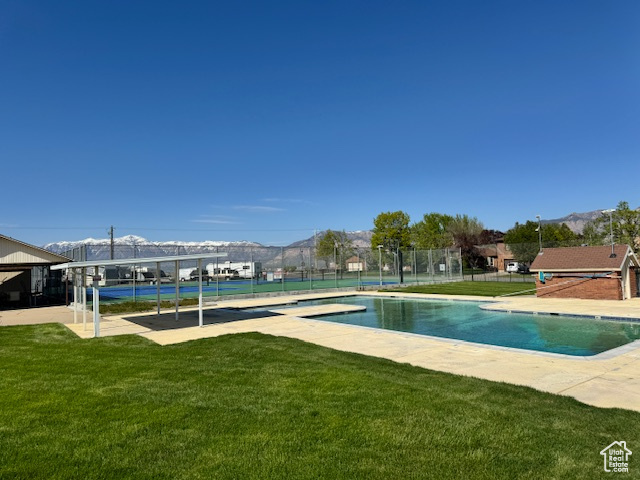 View of swimming pool featuring a lawn
