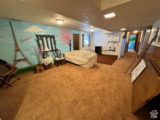 Bedroom featuring a textured ceiling and carpet