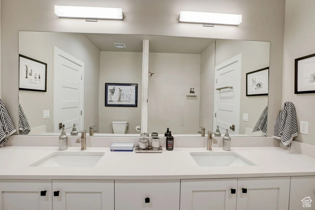 Bathroom with dual vanity and toilet