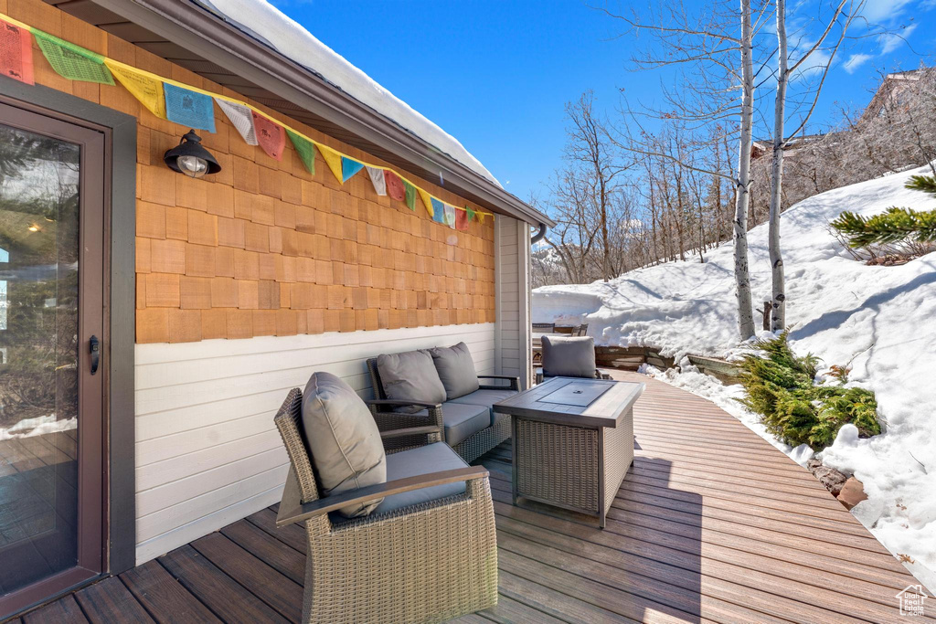 Snow covered deck with an outdoor living space
