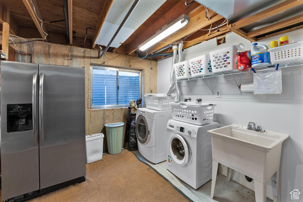 Laundry area featuring independent washer and dryer and sink