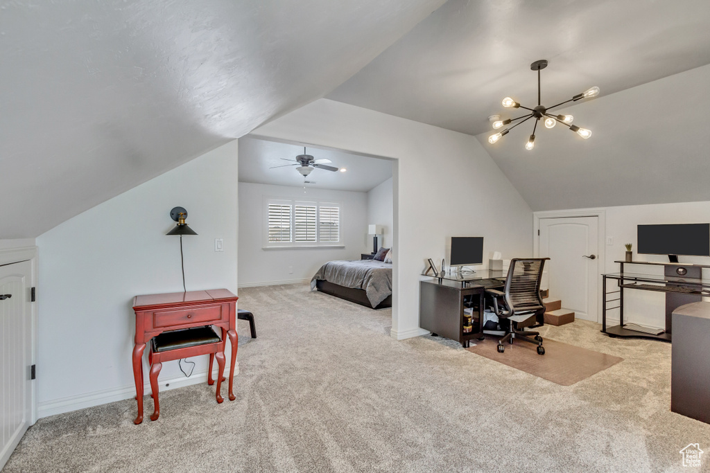 Office space featuring light colored carpet, ceiling fan with notable chandelier, and vaulted ceiling