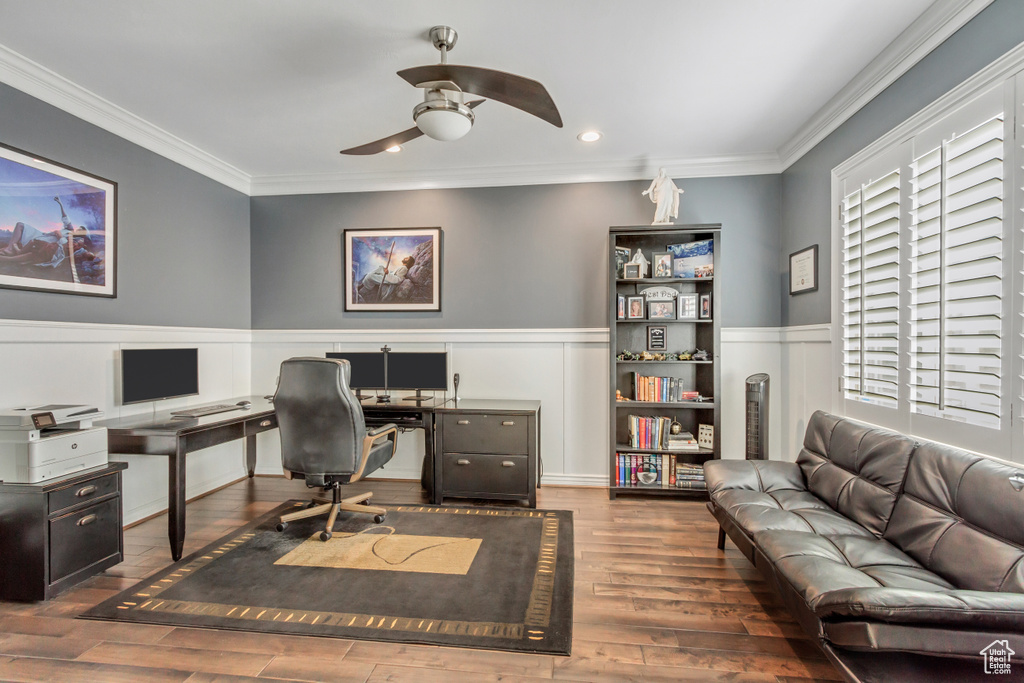 Office space featuring ornamental molding, dark hardwood / wood-style flooring, and ceiling fan