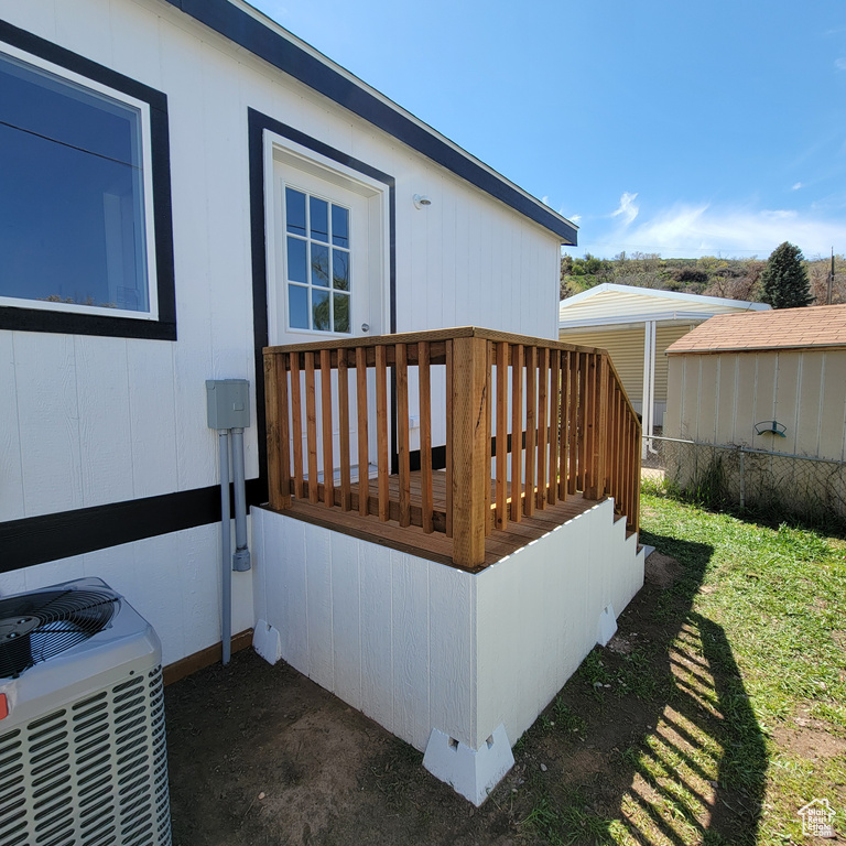 Wooden deck with a yard and central air condition unit