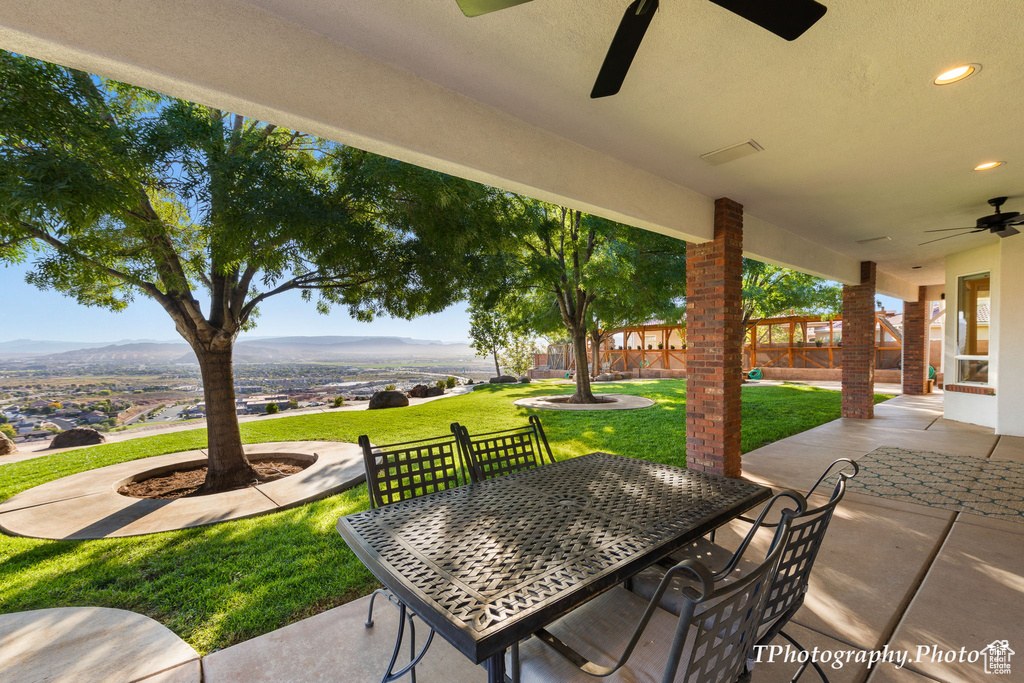 View of patio / terrace featuring ceiling fan and a mountain view