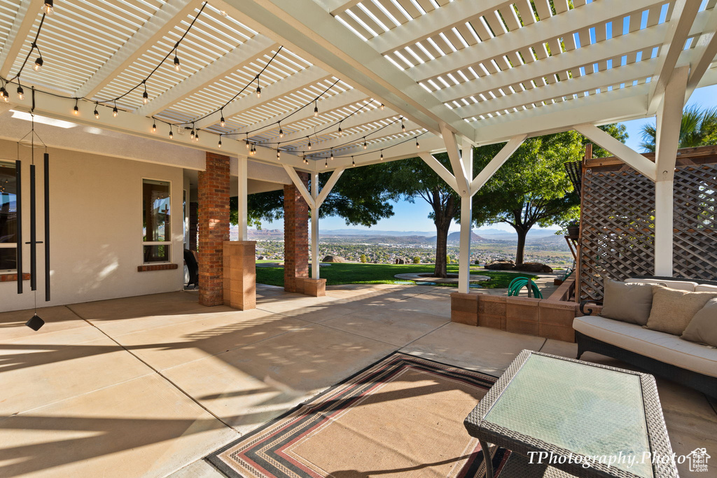 View of patio featuring an outdoor living space and a pergola