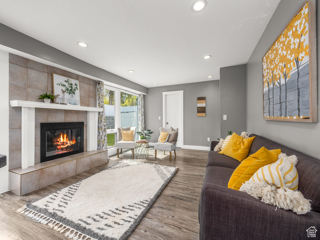 Living room featuring a tile fireplace and hardwood / wood-style floors