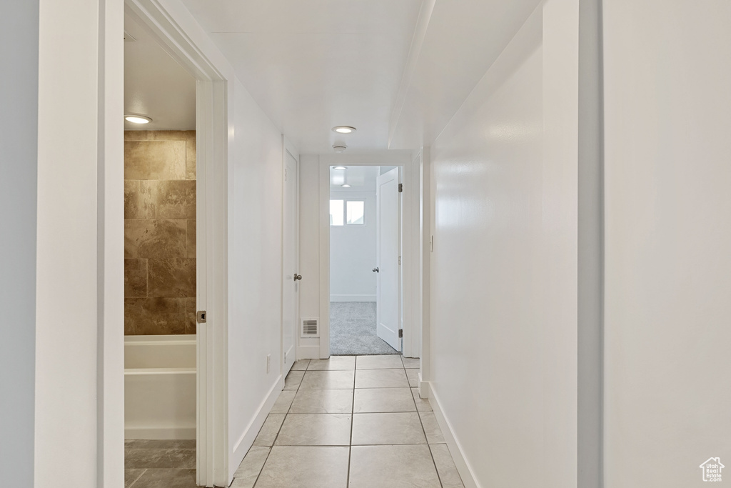 Hall with light tile flooring