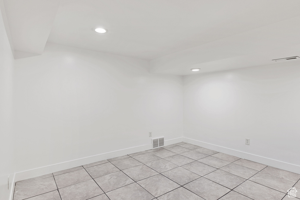 Empty room featuring light tile floors