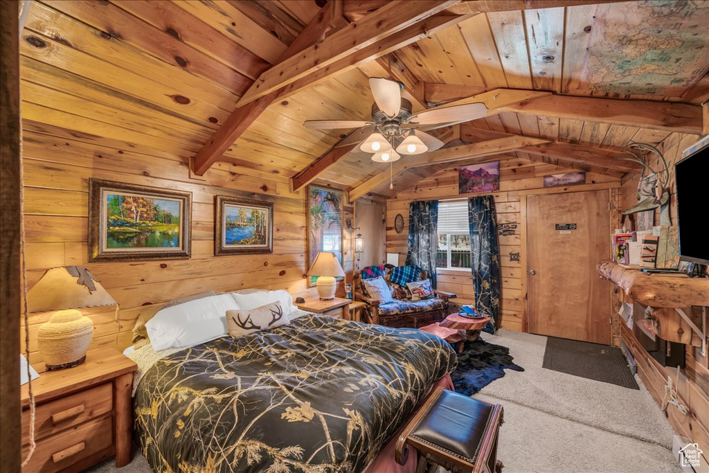 Bedroom with wooden ceiling, wood walls, and carpet flooring