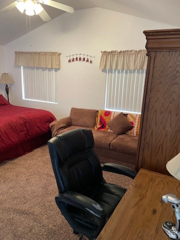 Bedroom with carpet, ceiling fan, and vaulted ceiling