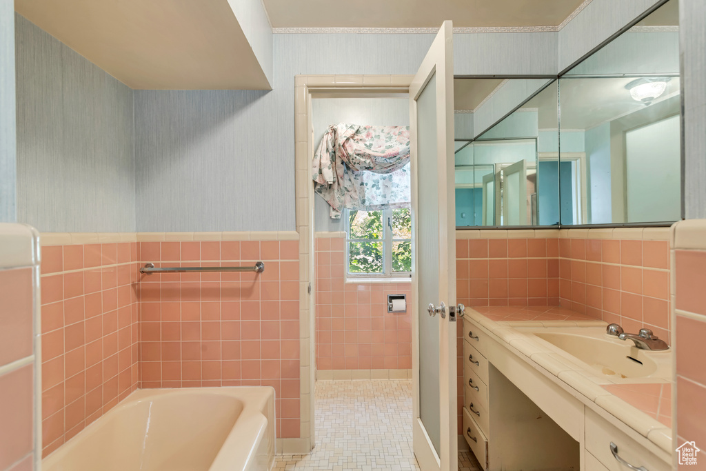 Bathroom with oversized vanity, tile floors, and tile walls