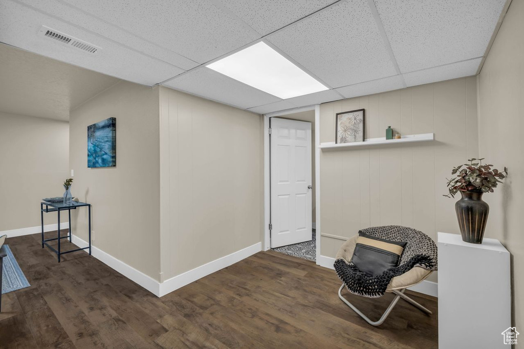 Office space featuring a drop ceiling and dark hardwood / wood-style flooring