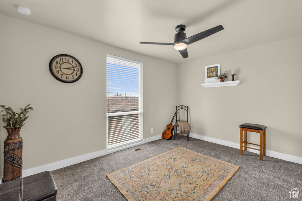Misc room featuring dark carpet and ceiling fan