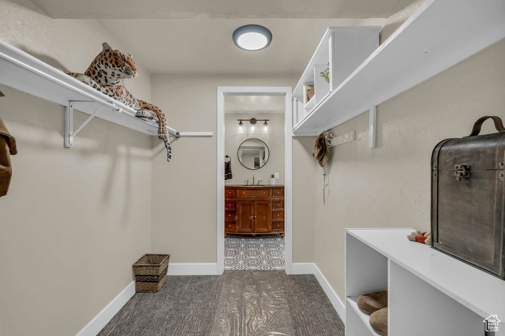 Spacious closet featuring sink and tile flooring