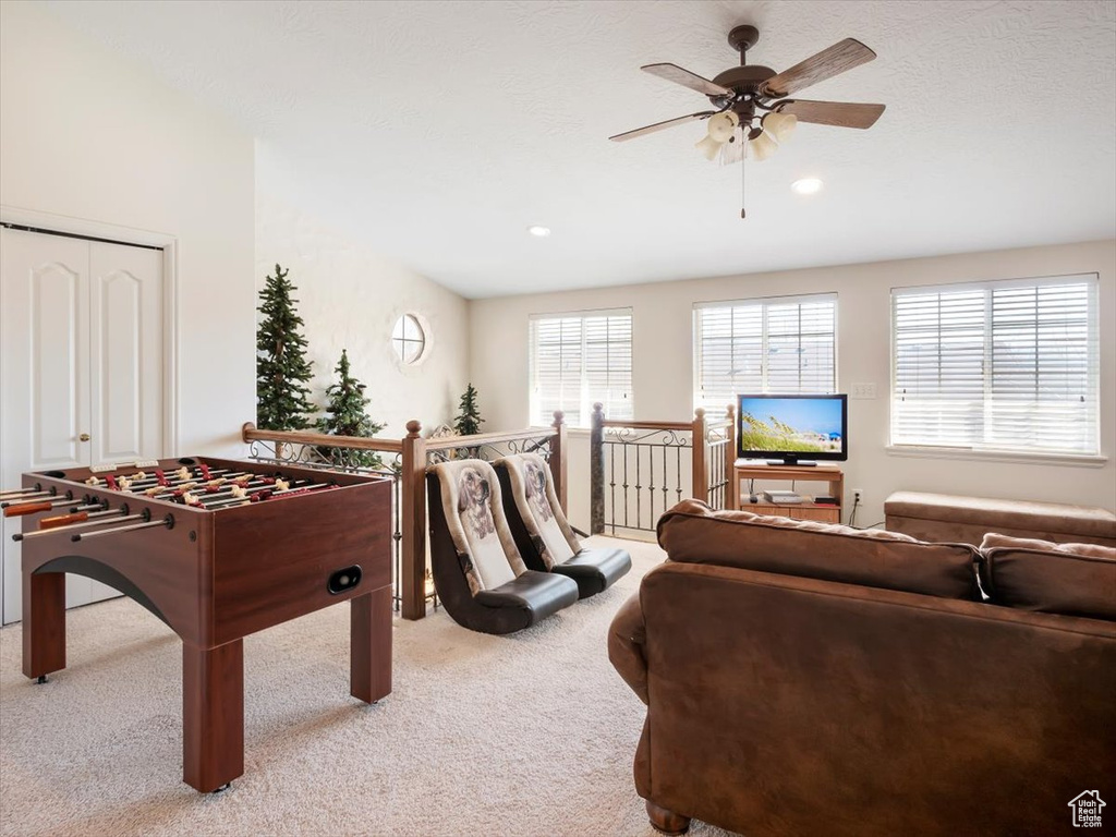 Interior space featuring ceiling fan and light carpet