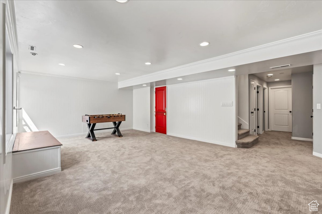 Basement with carpet and ornamental molding