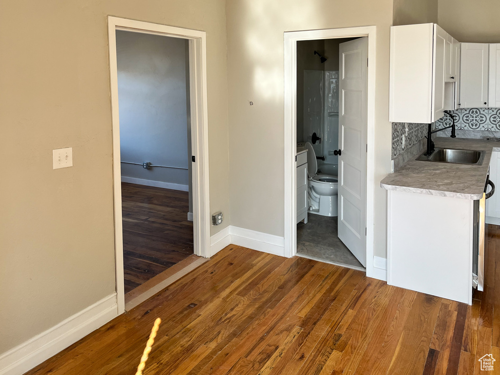 Corridor with sink and dark hardwood / wood-style flooring