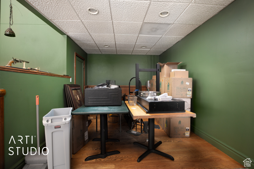 Office featuring a paneled ceiling and hardwood / wood-style flooring