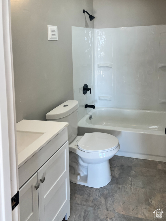 Full bathroom with toilet, tile flooring, vanity, and shower / bathtub combination