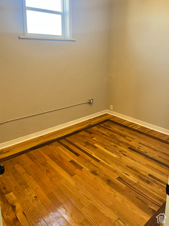 Empty room featuring wood-type flooring