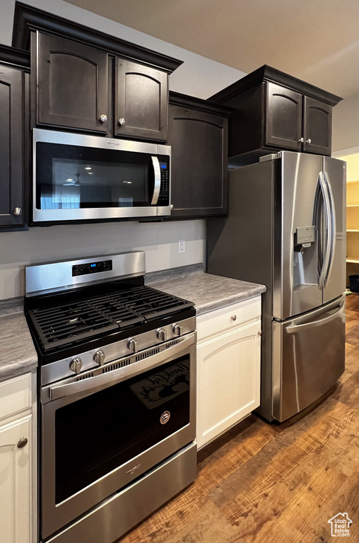Kitchen with stainless steel appliances and dark wood-type flooring