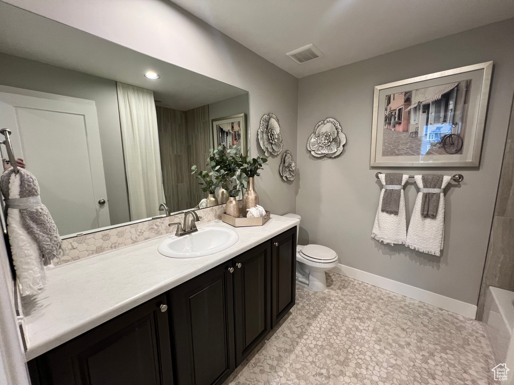 Full bathroom featuring shower / washtub combination, vanity, toilet, and tile flooring