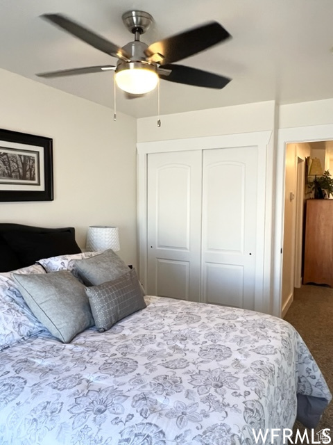 Bedroom featuring carpet flooring, a closet, and ceiling fan
