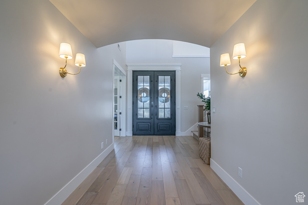 Foyer featuring lofted ceiling and hardwood / wood-style flooring
