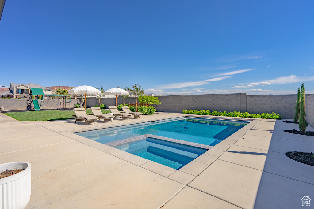 View of pool featuring a patio and an in ground hot tub