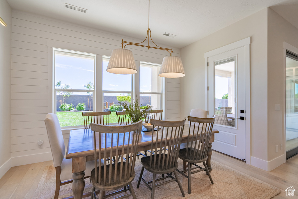 Dining area with plenty of natural light and light hardwood / wood-style floors