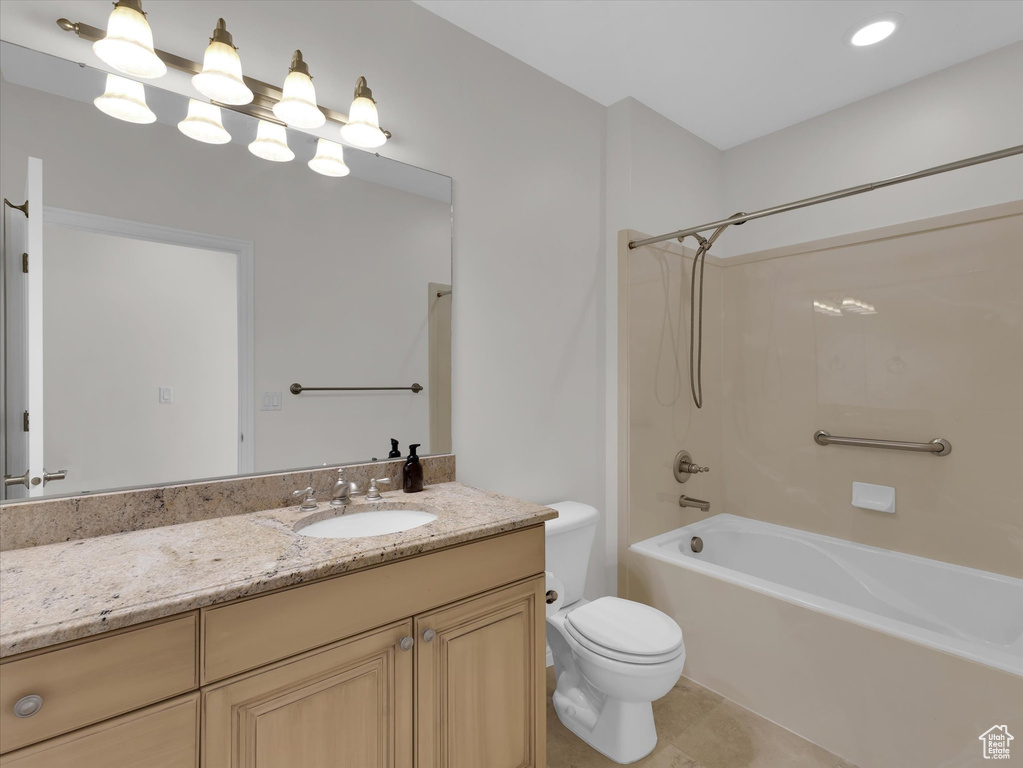 Full bathroom with tile flooring, vanity, toilet, and bathing tub / shower combination