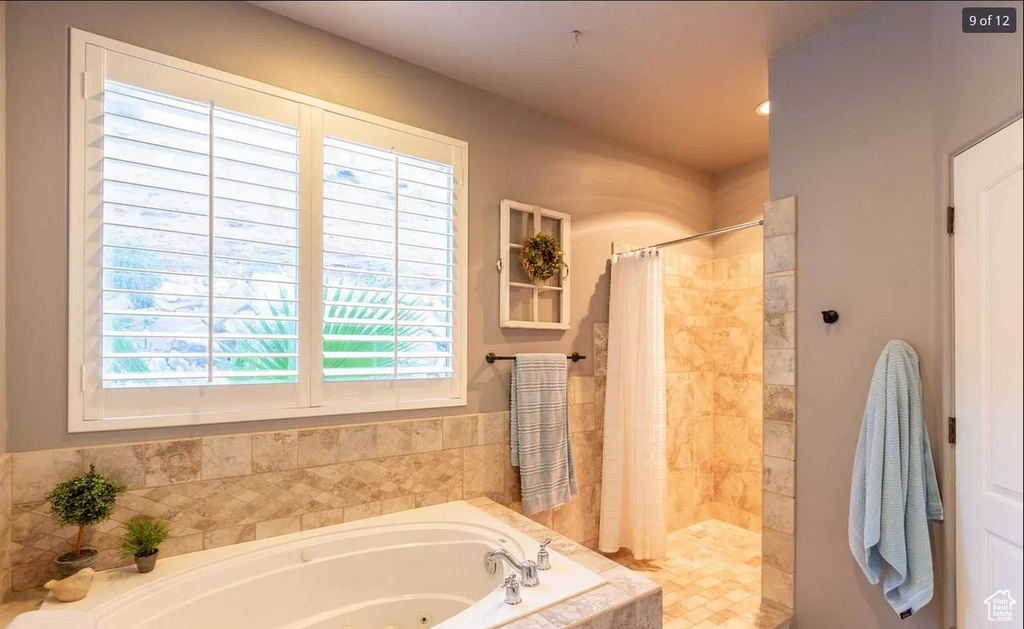 Bathroom with plenty of natural light and plus walk in shower