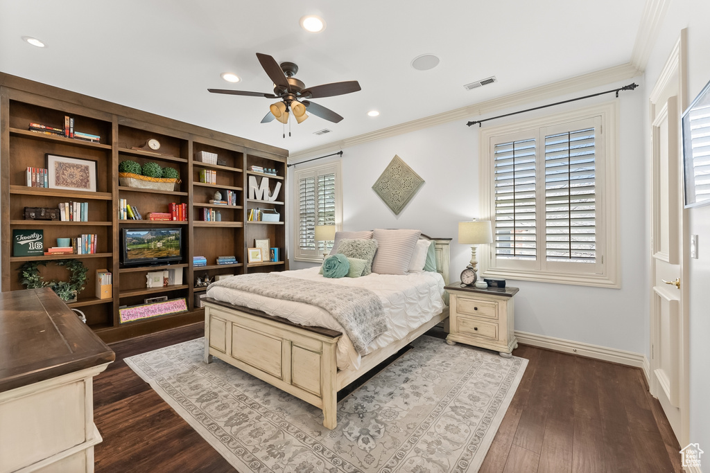 Bedroom featuring multiple windows, crown molding, ceiling fan, and dark hardwood / wood-style floors