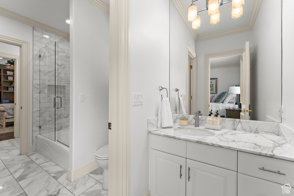 Bathroom featuring crown molding, toilet, tile floors, and vanity
