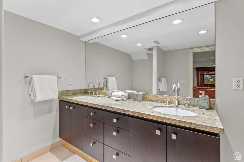 Bathroom featuring dual sinks, tile floors, and oversized vanity