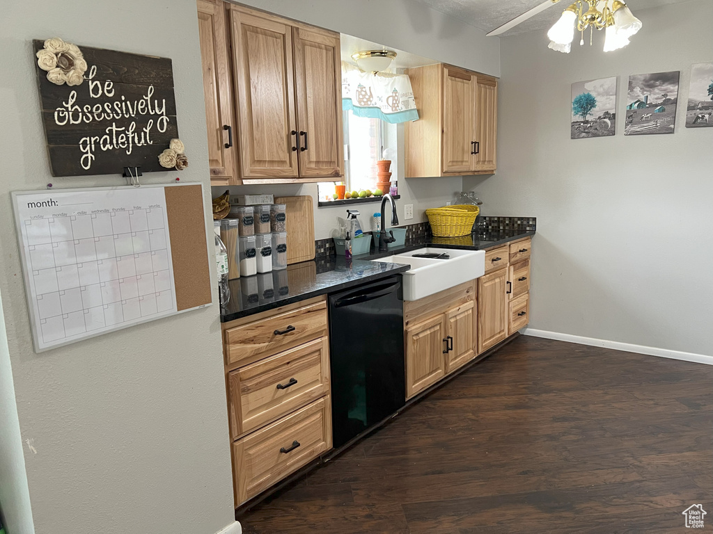 Kitchen featuring dark wood-type flooring, dishwasher, ceiling fan, and sink
