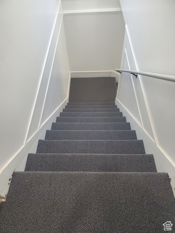 Stairway featuring carpet flooring