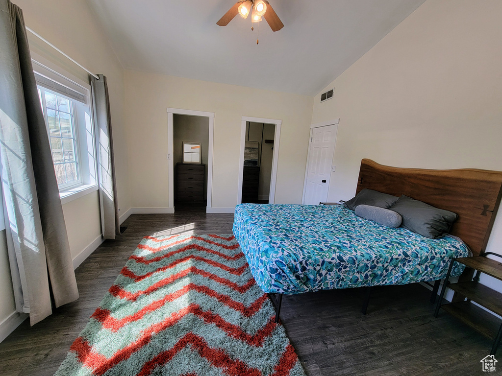 Bedroom featuring dark hardwood / wood-style floors, lofted ceiling, and ceiling fan