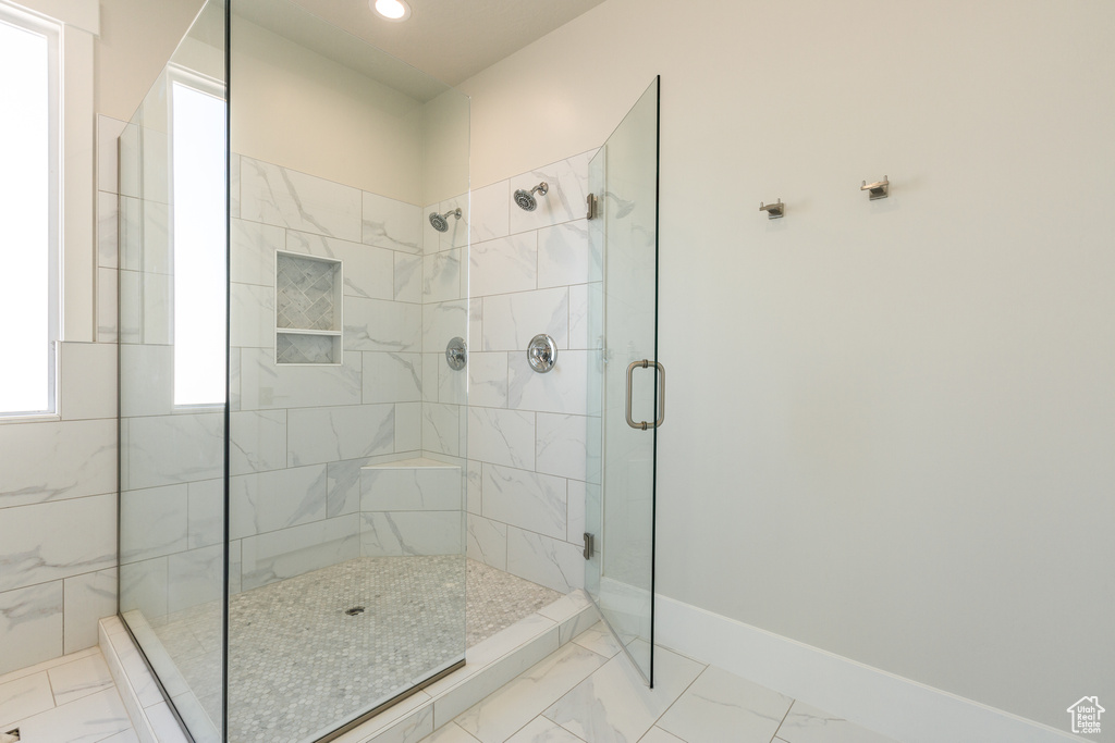 Bathroom featuring an enclosed shower and tile floors